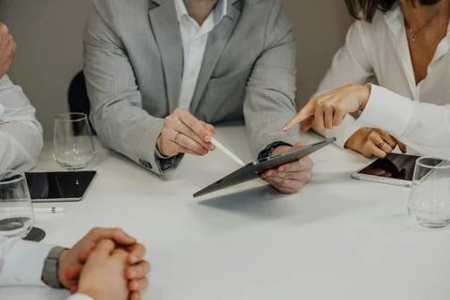 People looking at information on a tablet