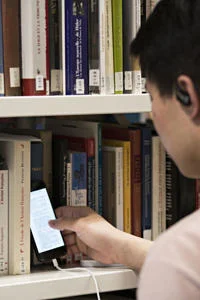 Student on their phone in the LSE Library