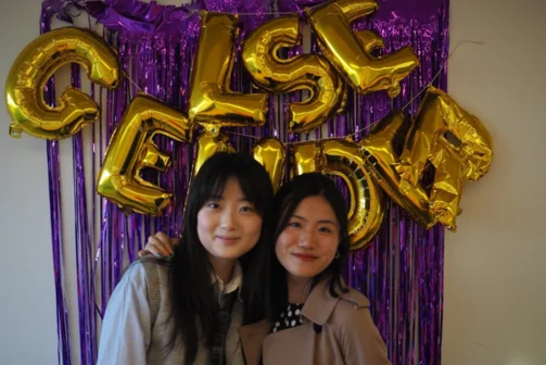 Two students smiling