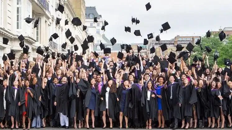 LSE graduates tossing their caps in the air.