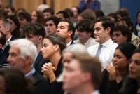 Audience seated in a lecture hall, attentively listening to a speaker during an LSE event.