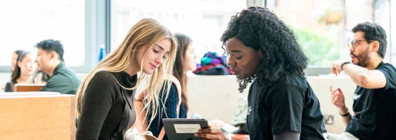 Two people looking at an iPad