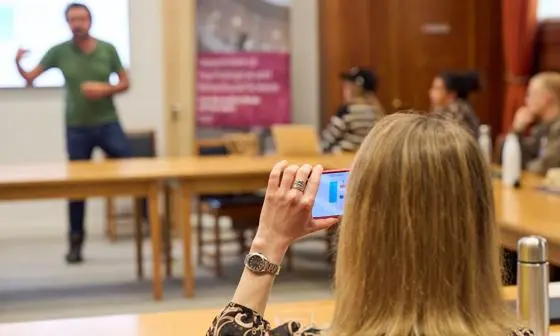 Participant taking photo at PBS and GSOS event