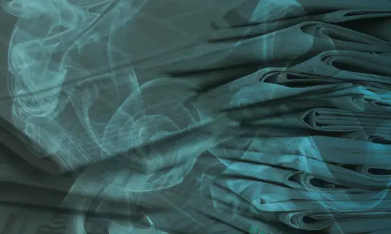 A pile of newspapers with smoke overlaid.