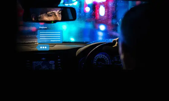 Reflection of a driver in the rearview mirror