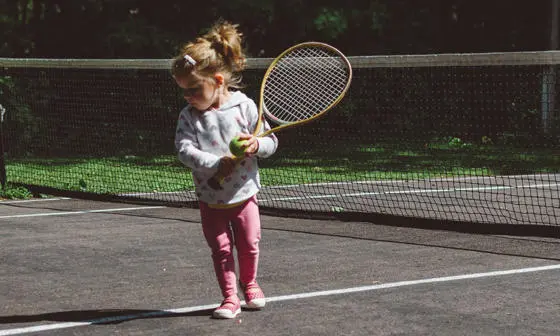 A child holding a tennis racquet