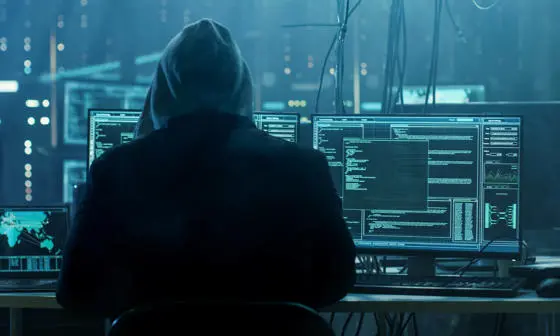 man sitting in front of computer screens