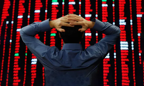 man looking at financial board