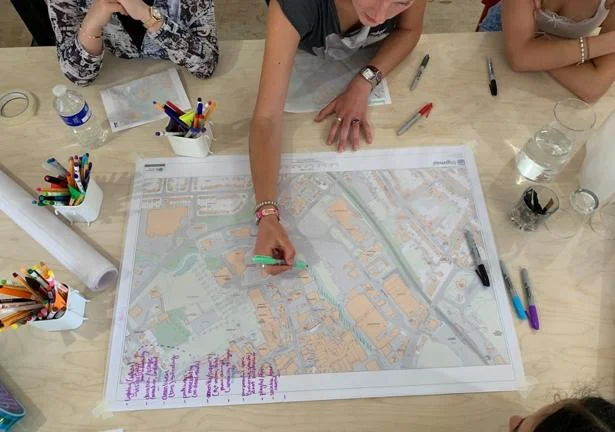 Researchers-in-residence in Trowbridge annotating a map with their interventions for better public spaces