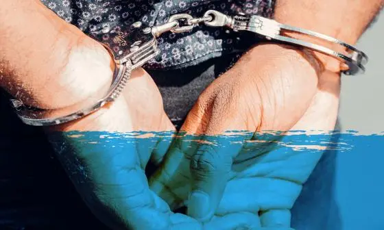 A pair of hands in handcuffs