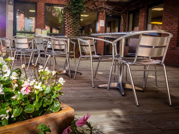 A communal garden with seating at a hall of residence