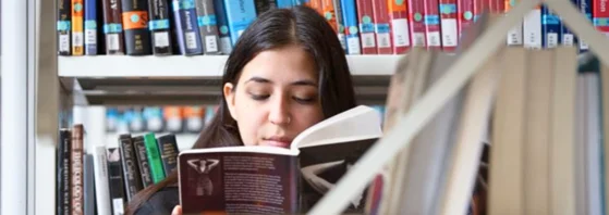 A girl reading in a library.
