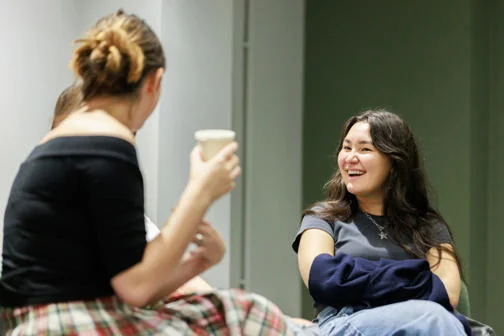 An image of two people talking whilst sitting down
