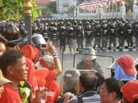 Red shirt protesters face by police in Thailand