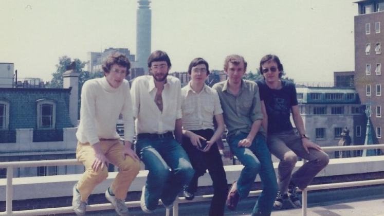 Peter Whitehead and his friends sit on a roof terrace during the 1970s with a view of the BT Tower in the background