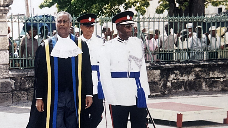 Sir David Simmons walks to inspect the Guard of Honour with the Barbados Police Commission on 6 October 2003