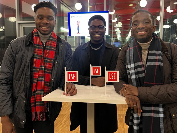 4 3 Three black men pose beside miniature LSE flags during the LSE Black Alumni Network lauch