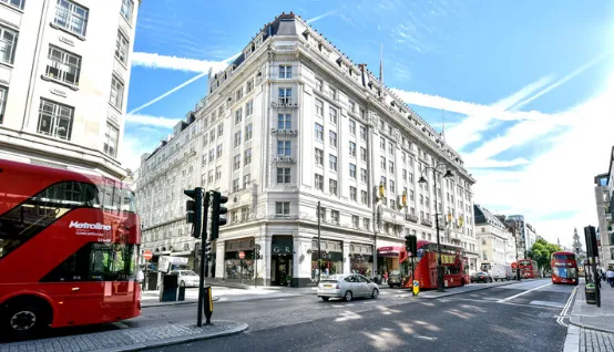 Strand Palace and red London buses on The Strand