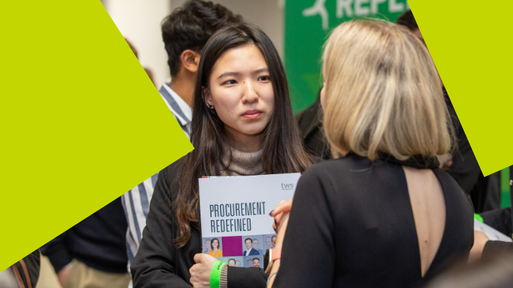 A person talks to another person at a careers fair