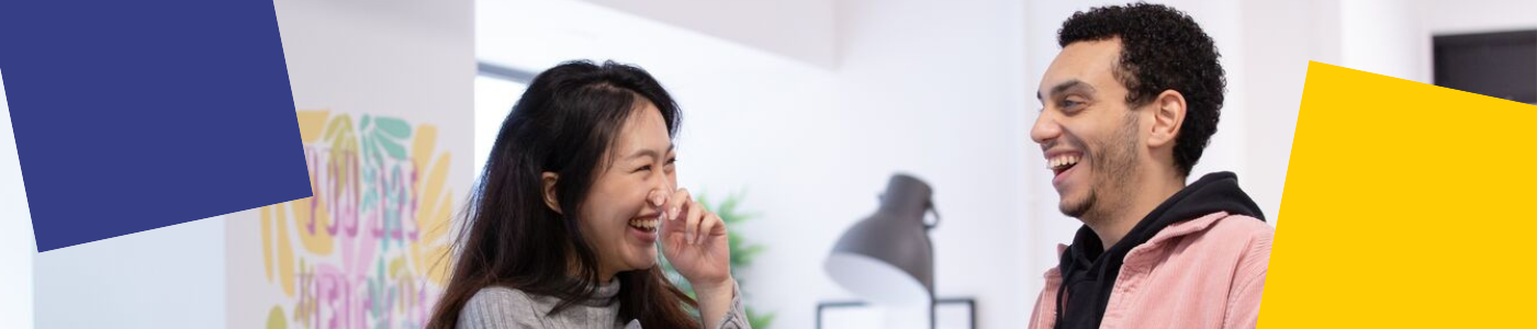 Two students laughing together