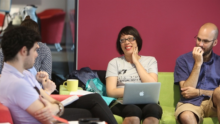 People sat on sofas in the PhD lab.