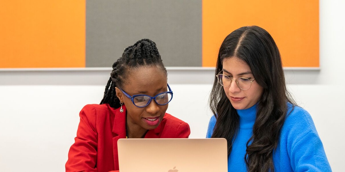 people sat together looking at a computer