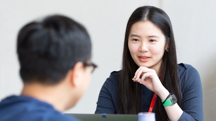 Two students talking 747x420