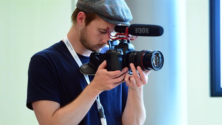 A person with a camera filming