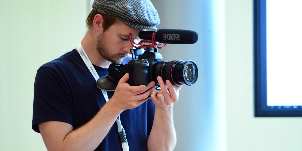 A person with a camera filming