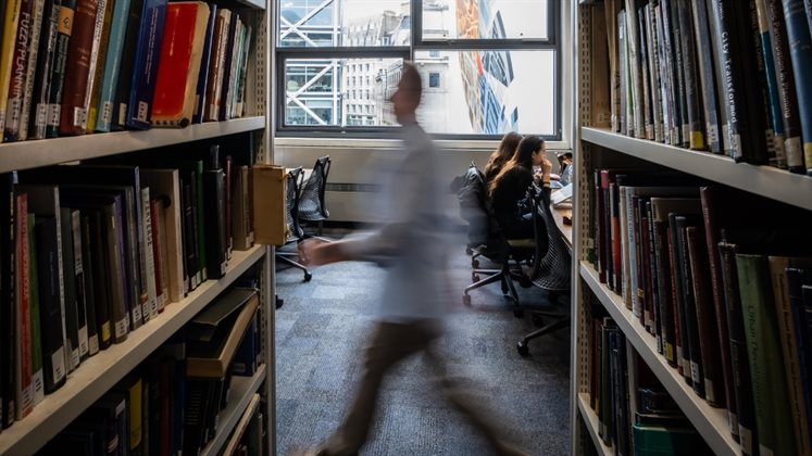 A view down the stacks as someone walks past