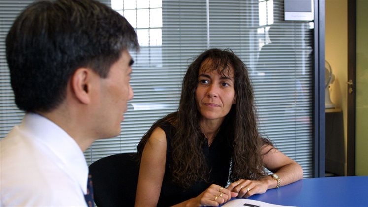 Two people sat at a desk