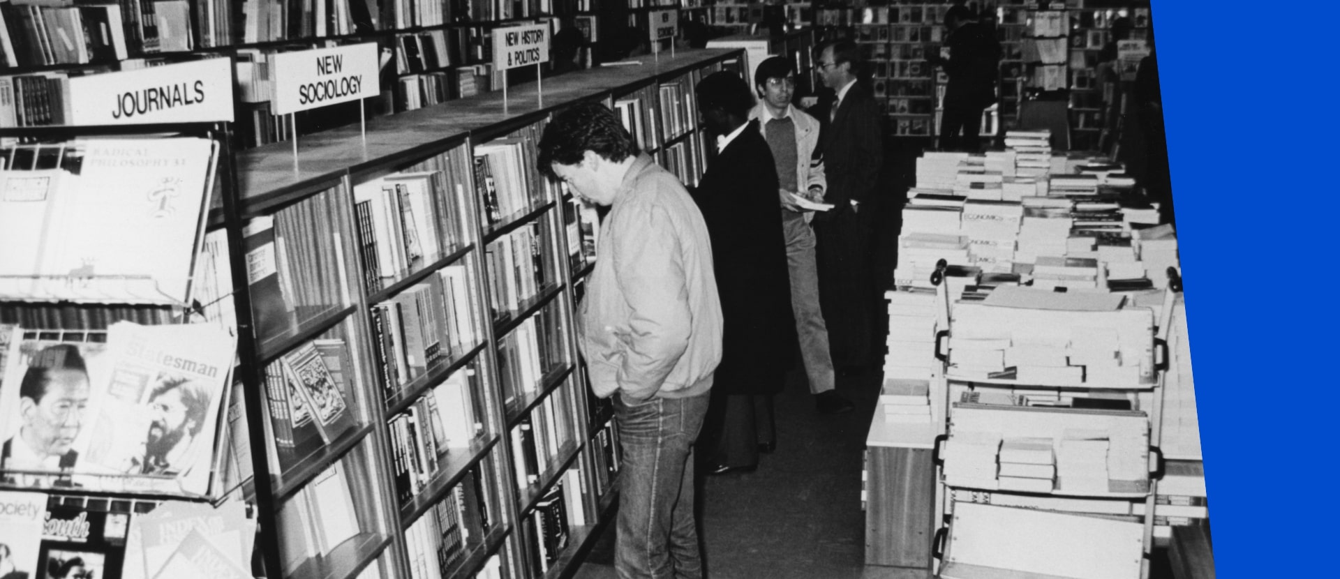 People stood in a bookshop looking at items on shelves