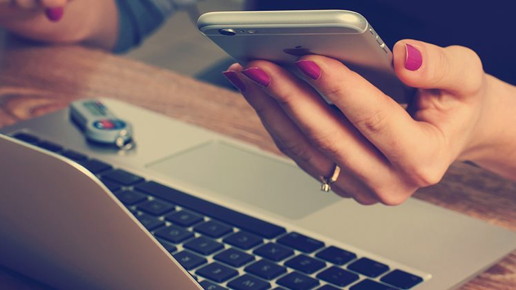 Business woman with phone and laptop