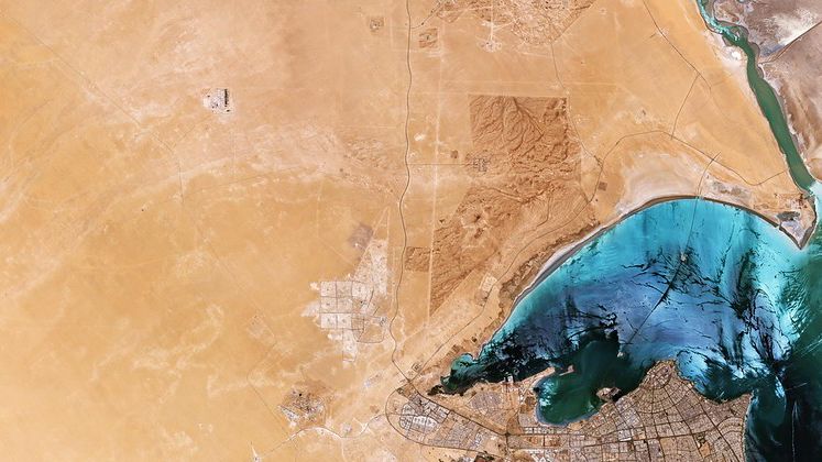 Satellite view of Kuwait City, with desert on the left and sea to the right, captured by the European Space Agency.