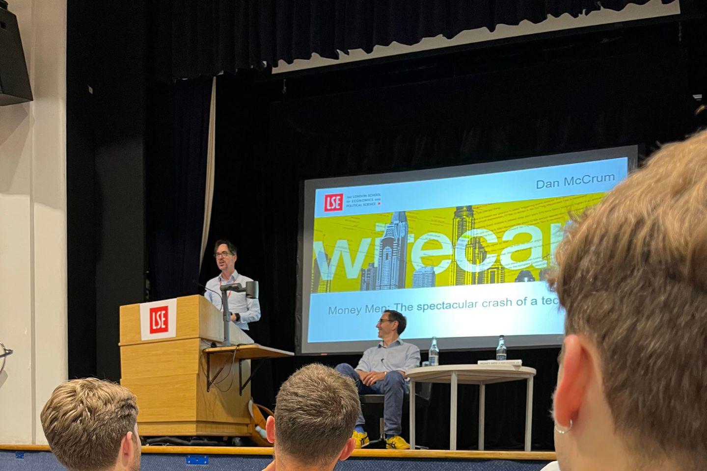 A man speaks at a lectern at an LSE event.